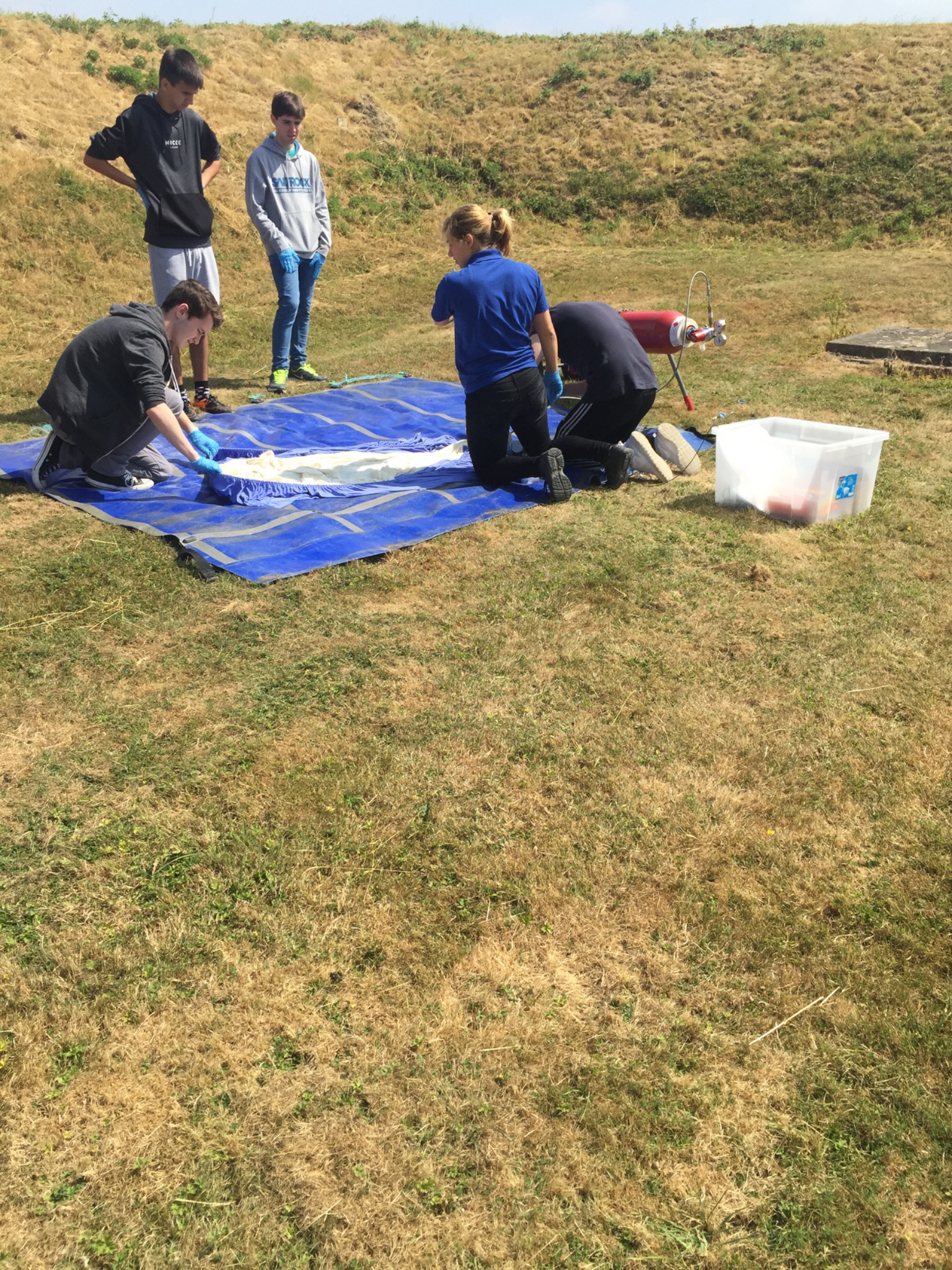 Team members preparing the balloon on a protective groundsheet